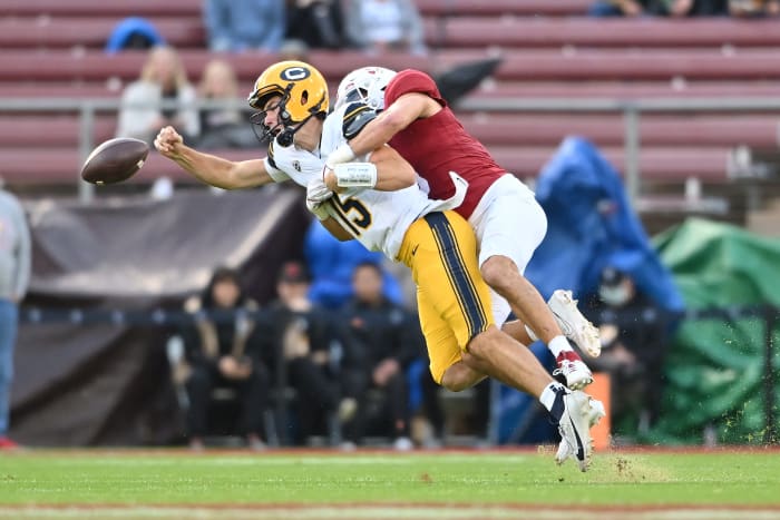 Nov 18, 2023; Stanford, California, USA; California Golden Bears quarterback Fernando Mendoza (15) throws an incomplete pass as he is tackled by Stanford Cardinal linebacker Tristan Sinclair (8) during the first quarter at Stanford Stadium. Mandatory Credit: Robert Edwards-USA TODAY Sports